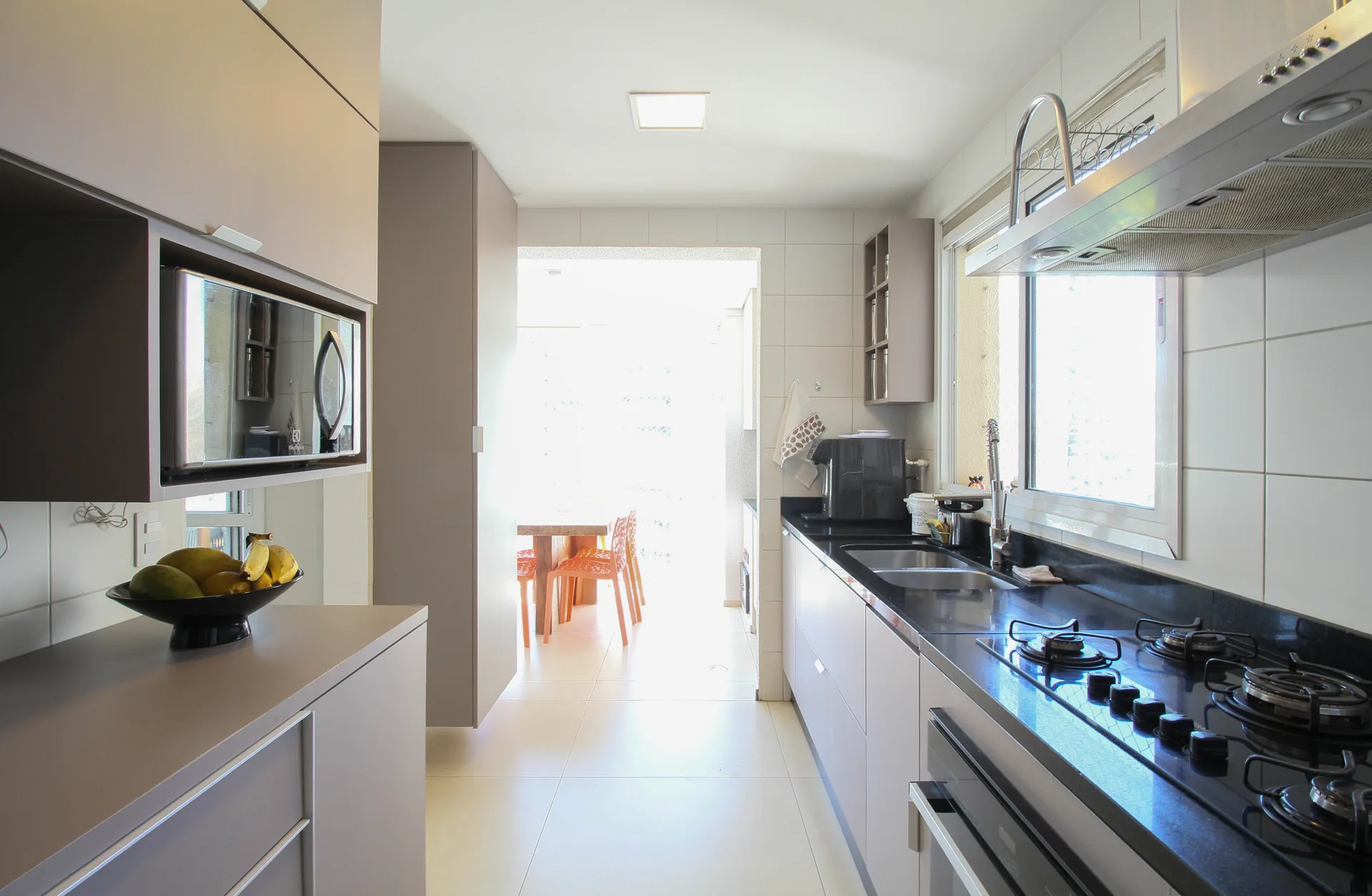 Cozinha planejada com armários e bancada em granito no apartamento do Condomínio Taman